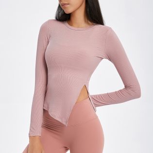 Cutout hem long-sleeve yoga top in a soft nude color featuring a smooth, comfortable ribbed fabric that hugs the body.